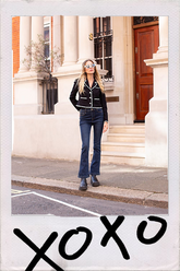 a lady in black cropped jacket with flared jeans